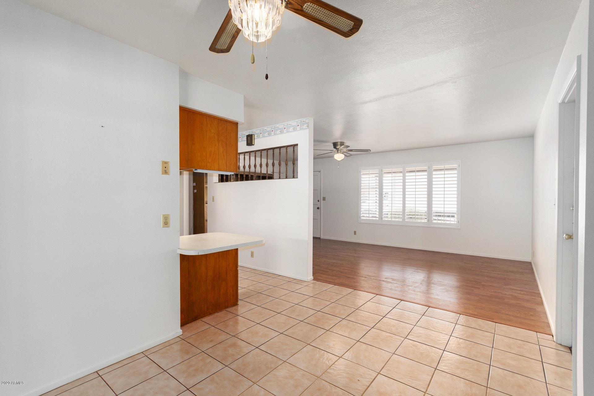 5704 East Decatur Street Mesa, AZ 85205 - Photo 17 of 40 an empty room with windows and ceiling fan