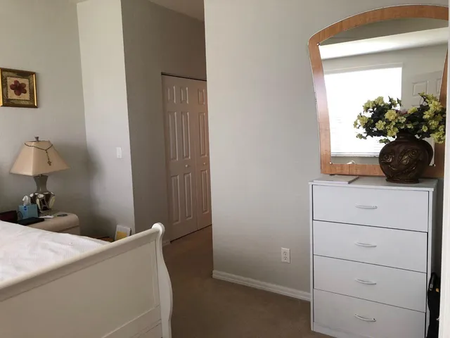 a bedroom with a bed and a dresser