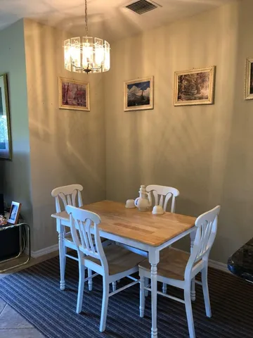 a view of a dining room with furniture wooden floor and chandelier
