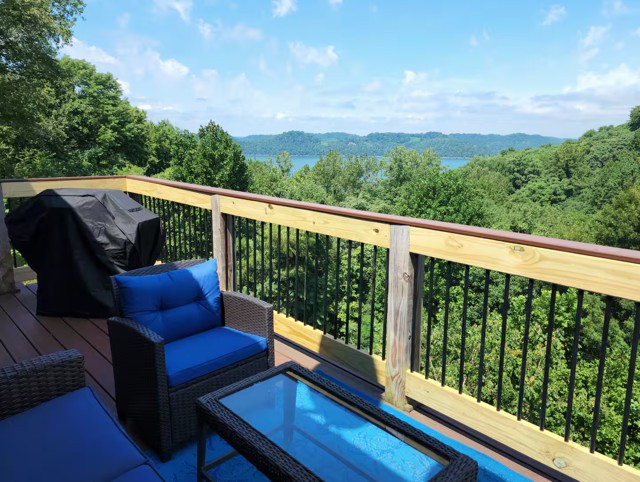 320 Floating Mill Road Silver Point, TN 38582 - Photo 2 of 40 a balcony with wooden floor and city view