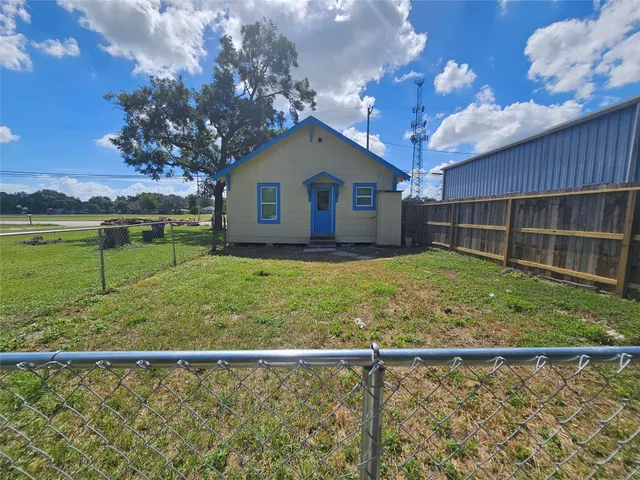 a view of a backyard with large trees and plants