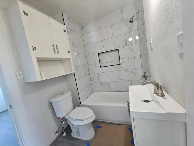 a white toilet sitting next to a bathroom sink