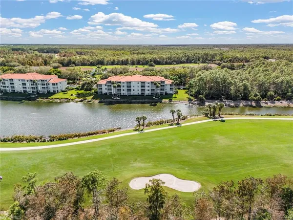an aerial view of a house with a lake view