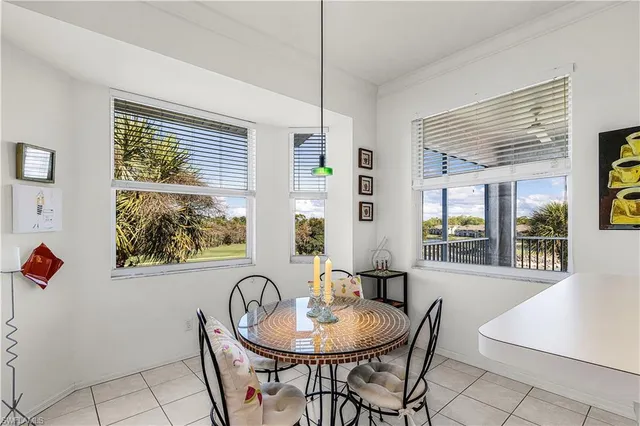 a view of a dining room with furniture and window