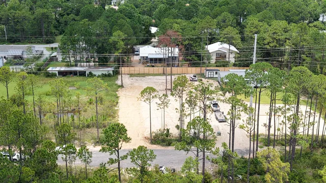 a front view of a house with a yard and lake view