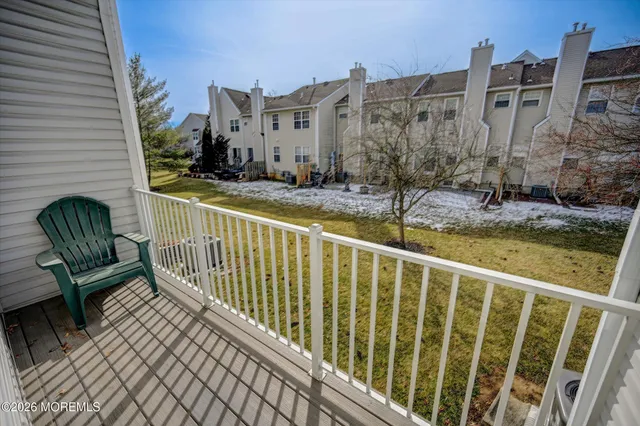 a view of a balcony with two chairs and a table