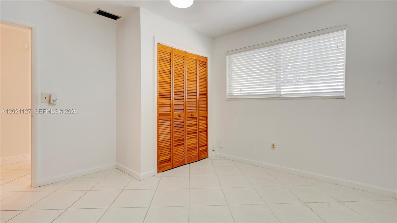 3611 Southwest 23rd Street Miami, FL 33145 - Photo 26 of 56 3613 - Bedroom 2 with an extra closet. Wood blinds in all bedrooms