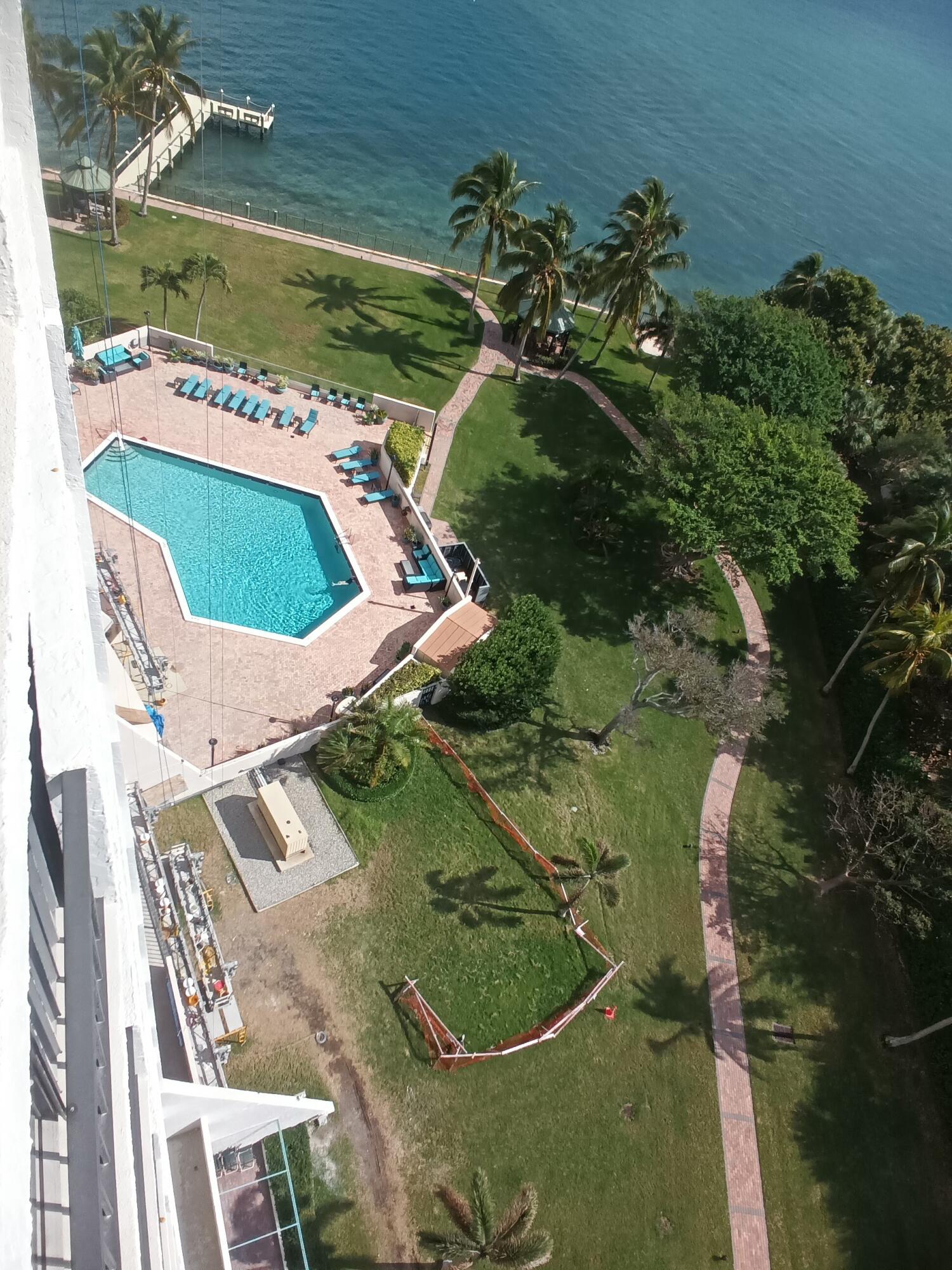 5200 North Flagler Drive, Unit 702 West Palm Beach, FL 33407 - Photo 20 of 36 a view of a swimming pool with a yard