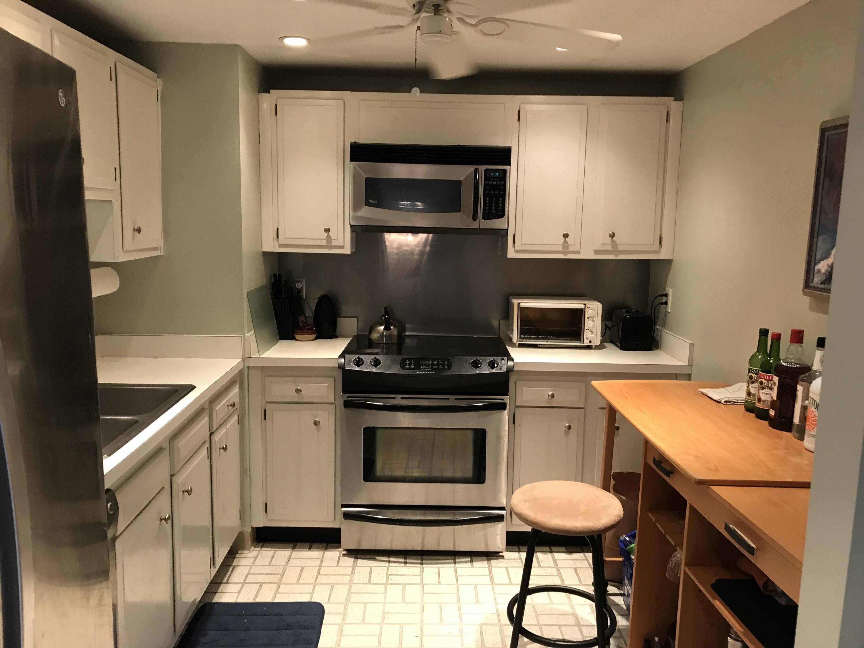 5200 North Flagler Drive, Unit 702 West Palm Beach, FL 33407 - Photo 29 of 36 a kitchen with a sink cabinets and appliances