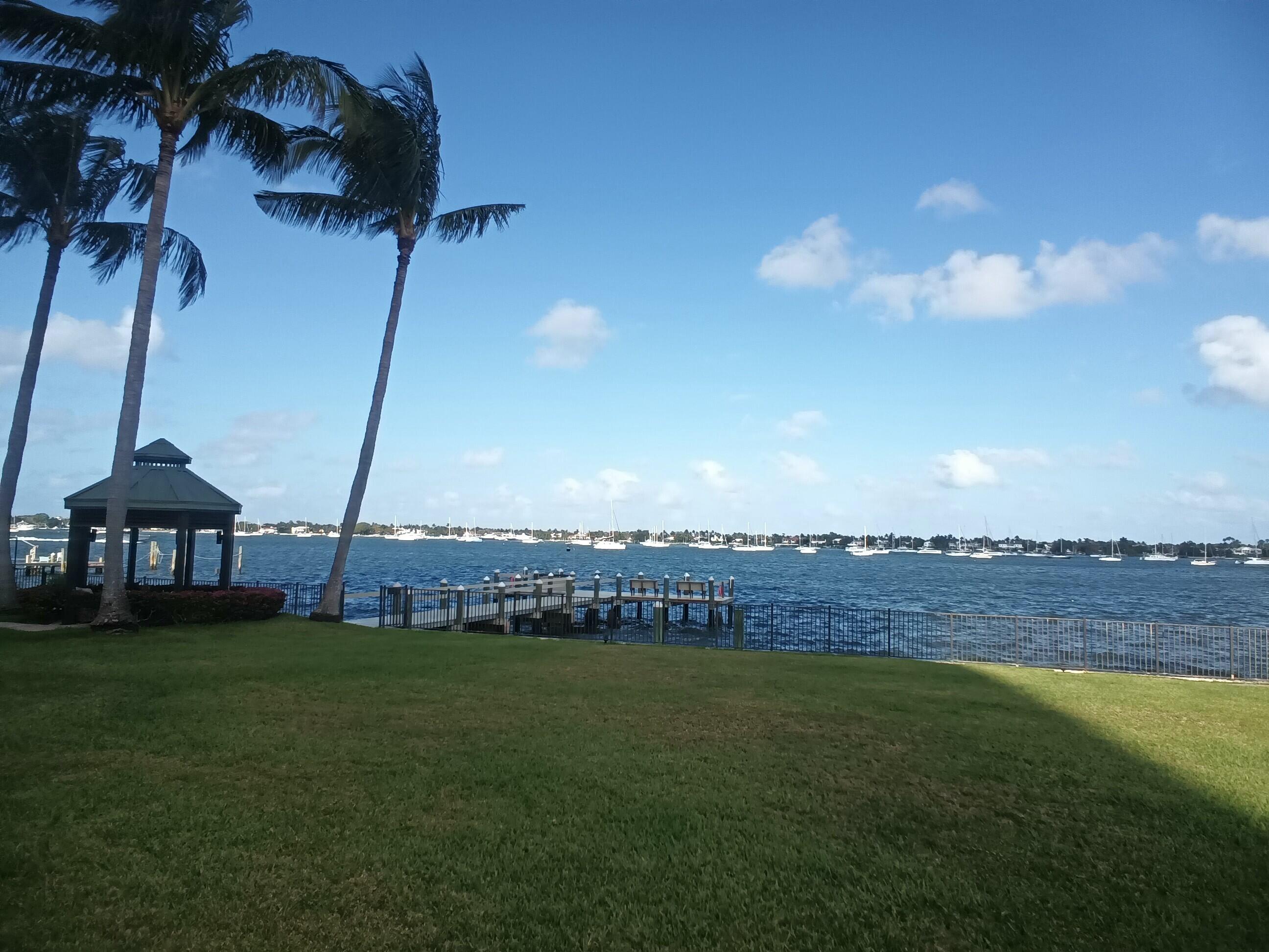5200 North Flagler Drive, Unit 702 West Palm Beach, FL 33407 - Photo 9 of 36 a view of a lake with a house swimming pool and outdoor space