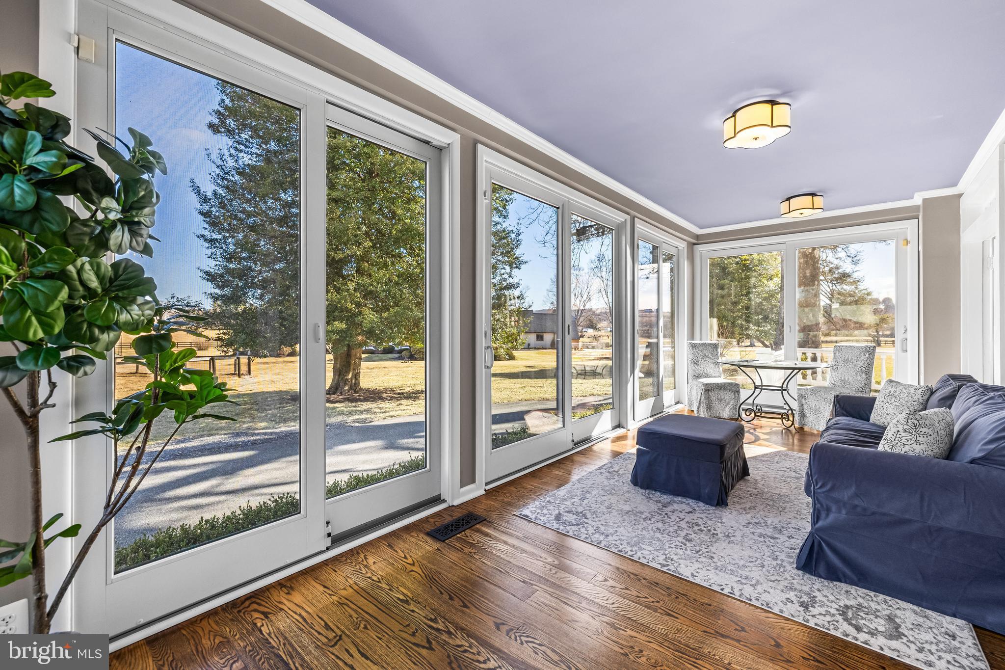 13128 Long Green Pike Baldwin, MD 21013 - Photo 28 of 124 a living room with furniture and a floor to ceiling window