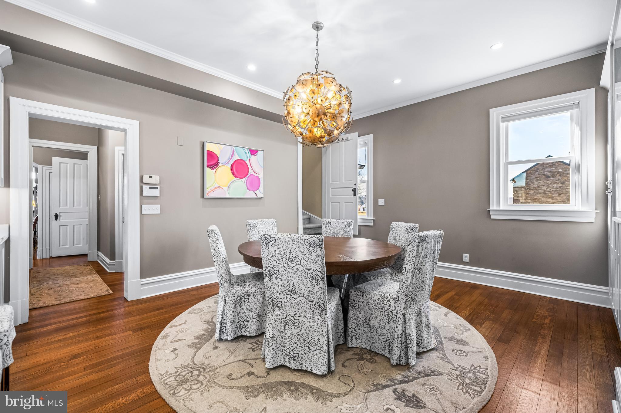 13128 Long Green Pike Baldwin, MD 21013 - Photo 38 of 124 a dining room with wooden floor a chandelier a wooden table and chairs