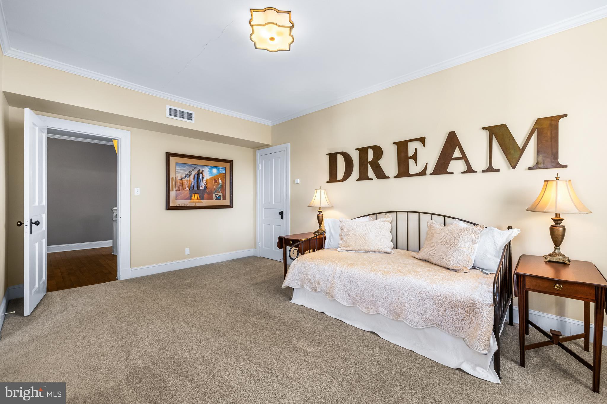 13128 Long Green Pike Baldwin, MD 21013 - Photo 64 of 124 a bedroom with a large bed and a painting on the wall