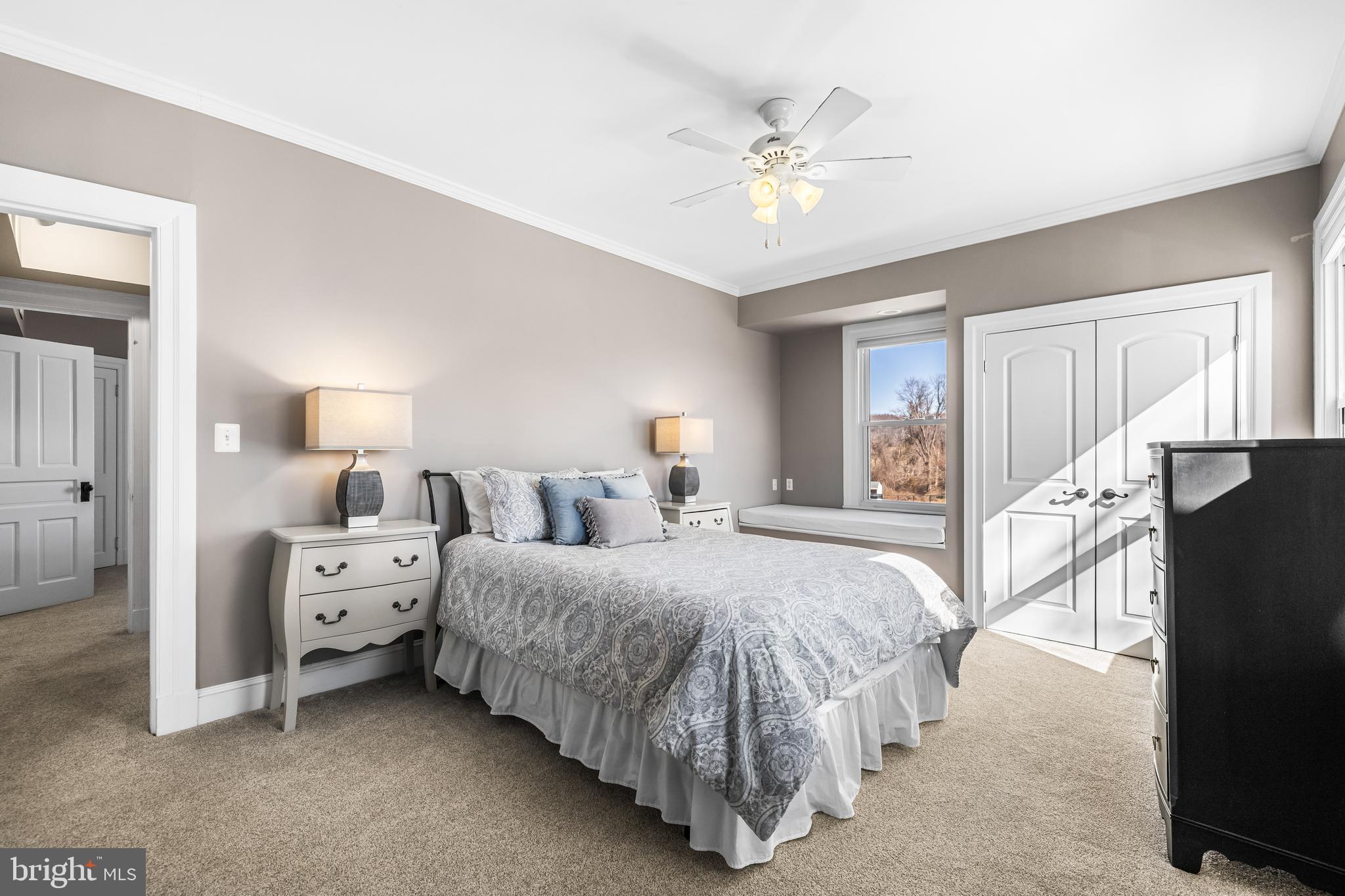 13128 Long Green Pike Baldwin, MD 21013 - Photo 71 of 124 a spacious bedroom with a bed and a chandelier