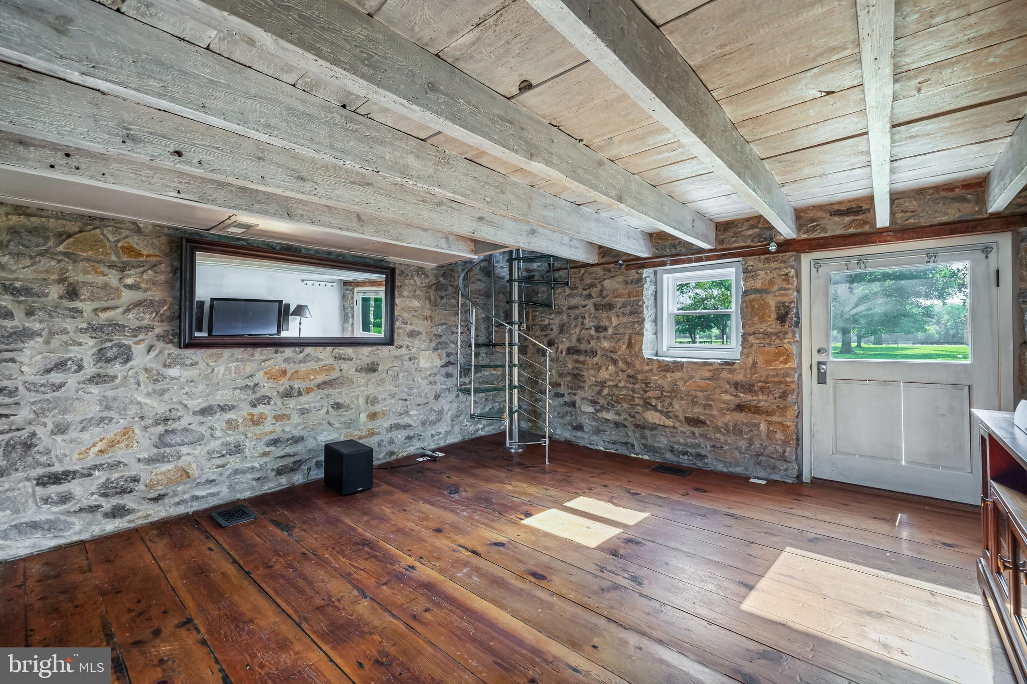 13128 Long Green Pike Baldwin, MD 21013 - Photo 90 of 124 a view of a livingroom with wooden floor and a ceiling fan