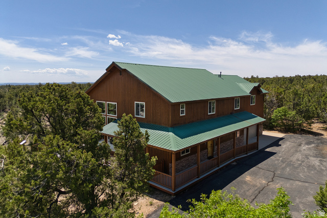 755 South Zion Ridge Drive Orderville, UT 84758 - Photo 4 of 84 View of side of home with a metal roof, a large porch, and driveway