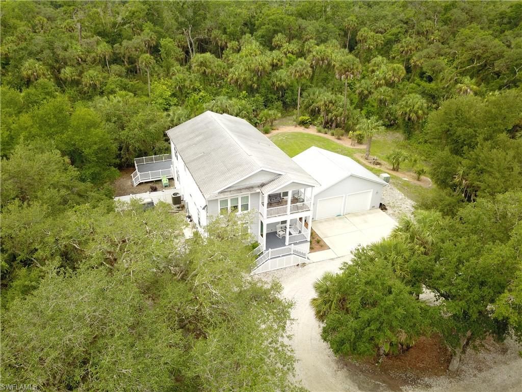 5680 Dana Road Fort Myers, FL 33905 - Photo 3 of 18 an aerial view of a house with swimming pool and large trees