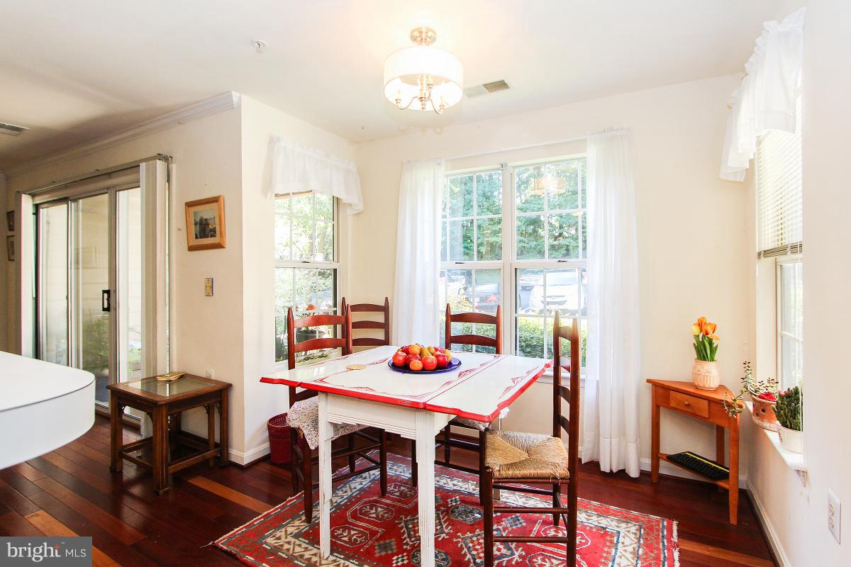 119 Timberbrook Lane, Unit 101 Gaithersburg, MD 20878 - Photo 11 of 29 a view of a dining room with furniture window and outside view