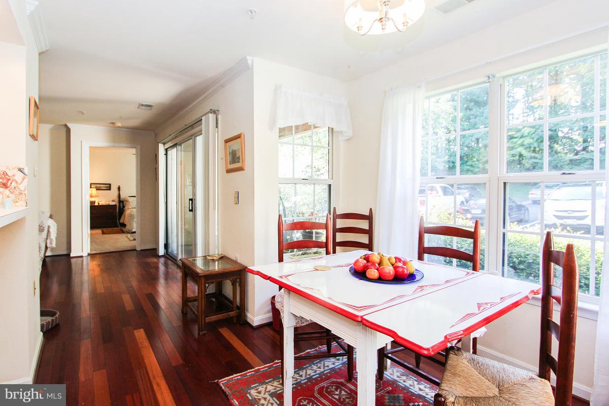 119 Timberbrook Lane, Unit 101 Gaithersburg, MD 20878 - Photo 12 of 29 a dining room with furniture and wooden floor