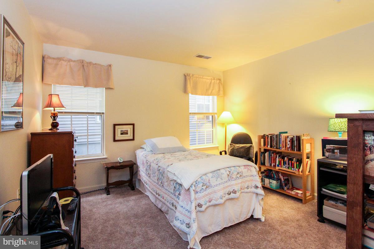 119 Timberbrook Lane, Unit 101 Gaithersburg, MD 20878 - Photo 20 of 29 a bedroom with a bed furniture and a large window