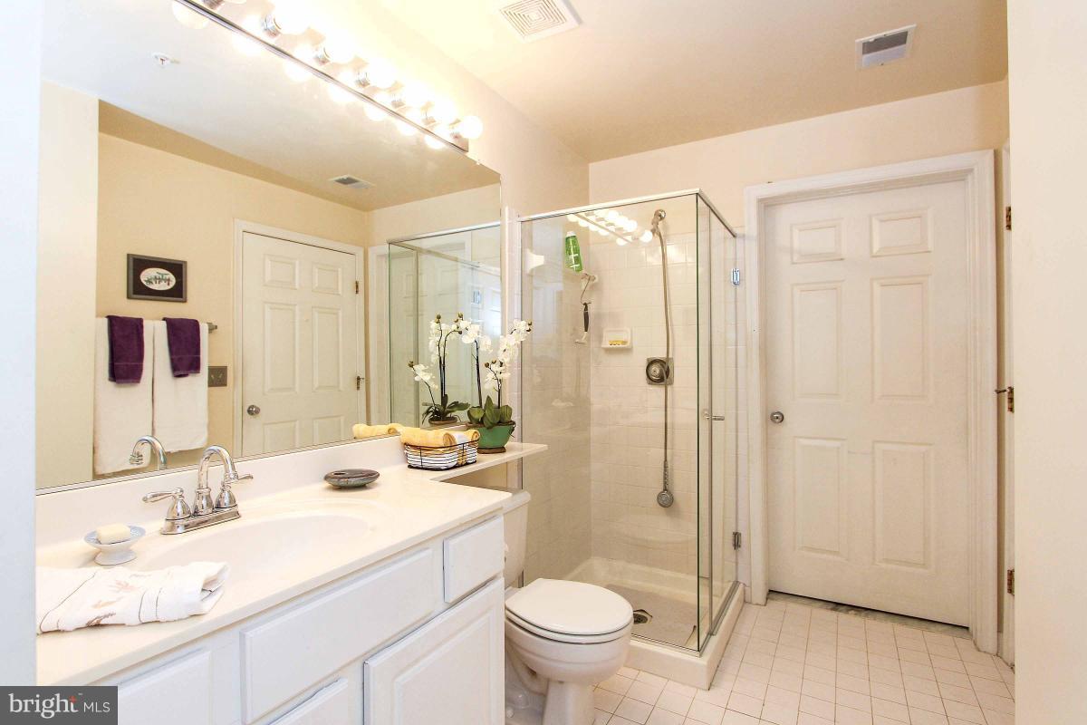 119 Timberbrook Lane, Unit 101 Gaithersburg, MD 20878 - Photo 22 of 29 a bathroom with a sink a toilet and shower