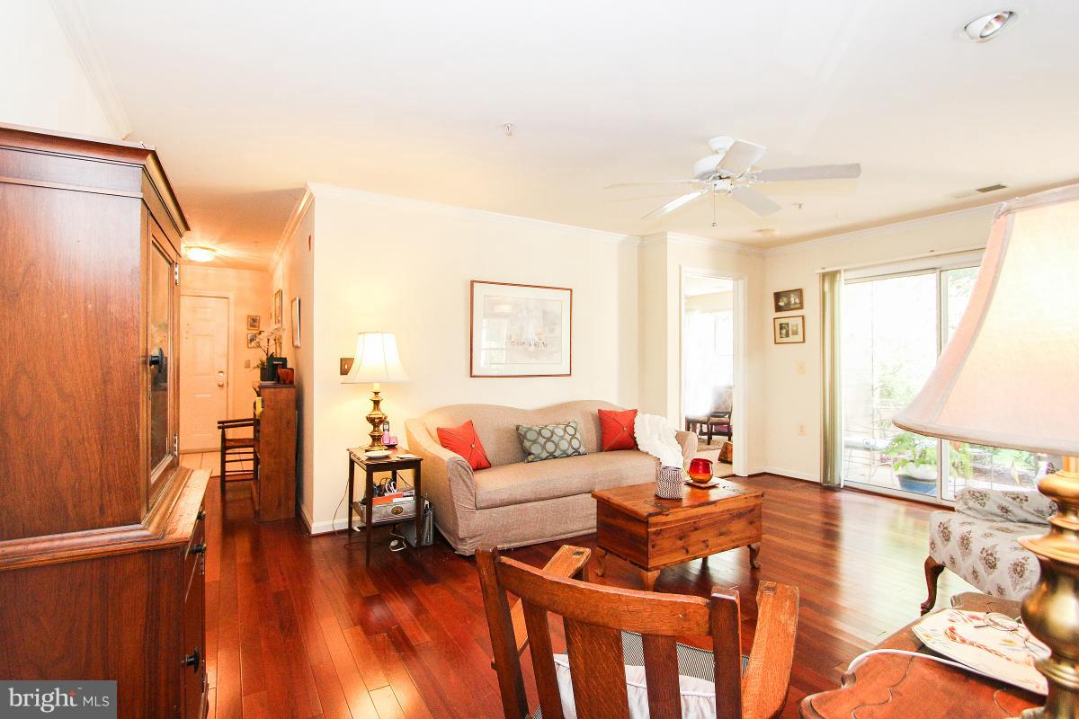 119 Timberbrook Lane, Unit 101 Gaithersburg, MD 20878 - Photo 7 of 29 a living room with furniture and a wooden floor