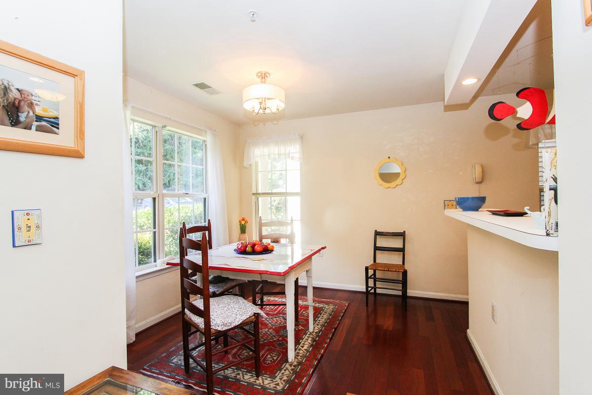 119 Timberbrook Lane, Unit 101 Gaithersburg, MD 20878 - Photo 9 of 29 a view of a dining room with furniture and wooden floor