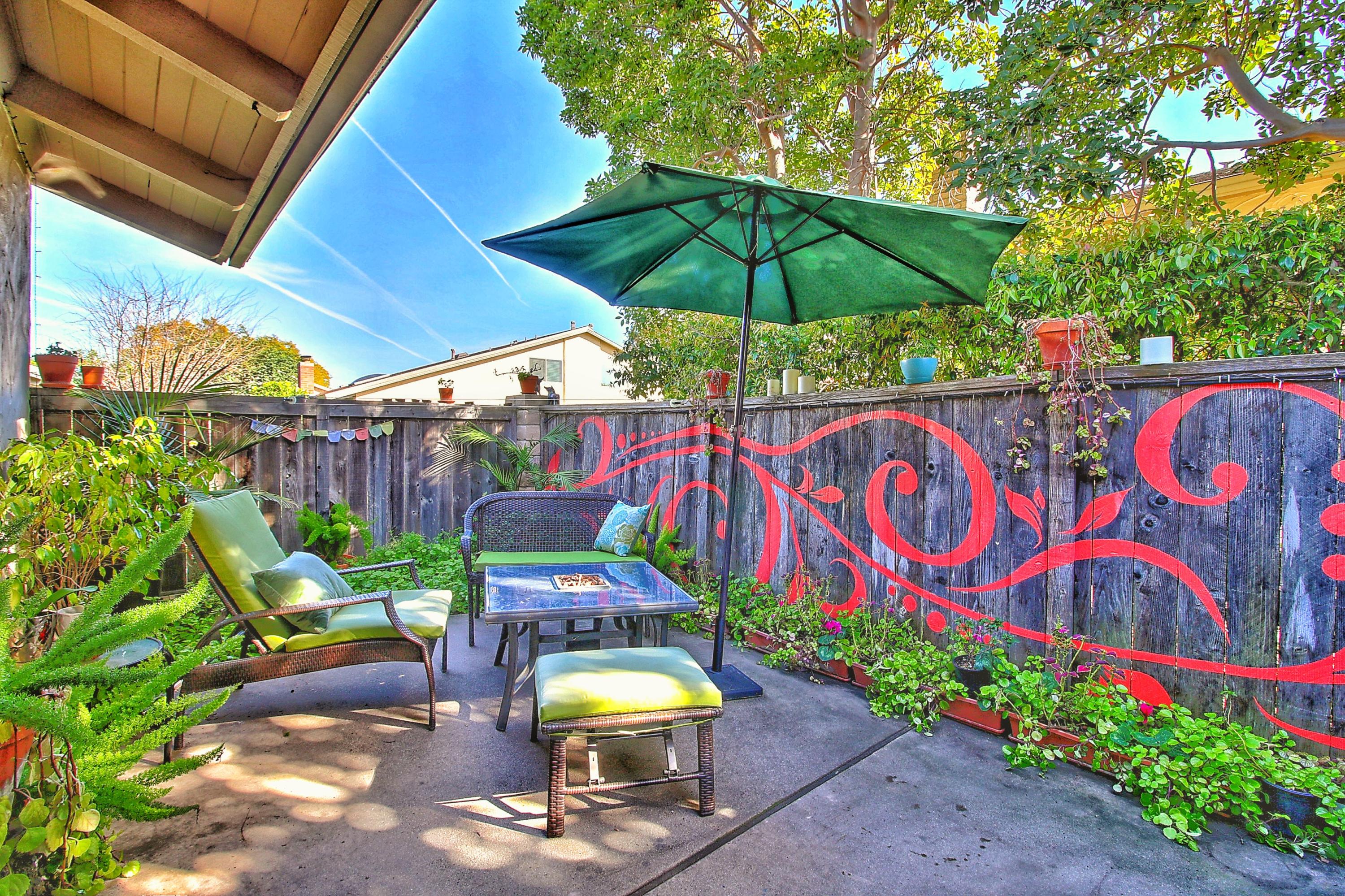 51 North San Marcos Road, Unit B Santa Barbara, CA 93111 - Photo 15 of 24 a view of a table and chairs under an umbrella in patio with a yard