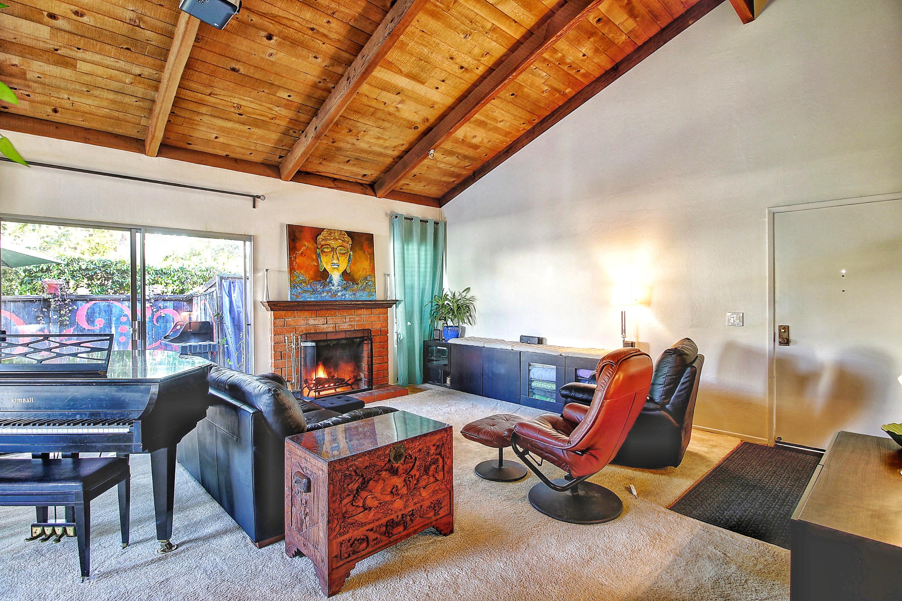 51 North San Marcos Road, Unit B Santa Barbara, CA 93111 - Photo 2 of 24 a living room with furniture a fireplace and a table