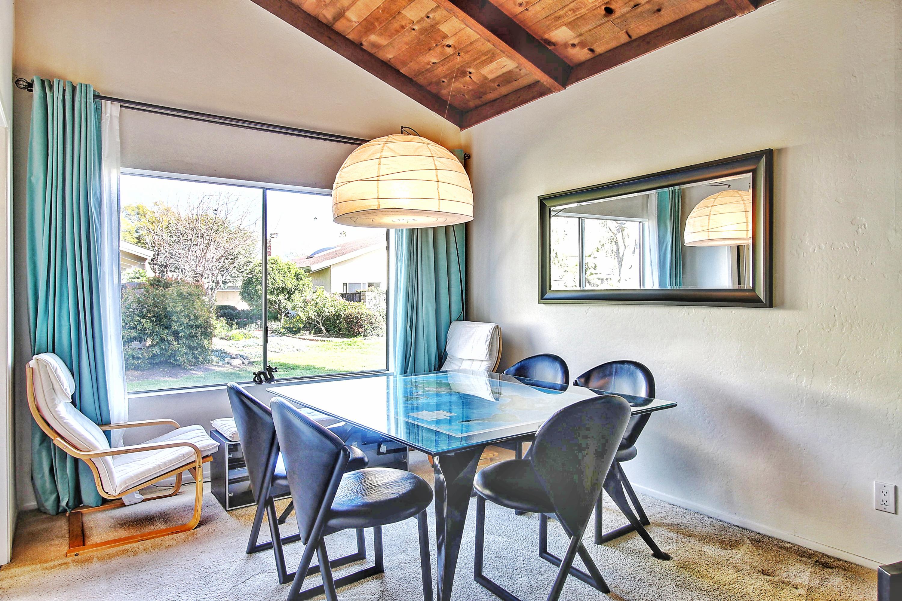 51 North San Marcos Road, Unit B Santa Barbara, CA 93111 - Photo 6 of 24 a view of a dining room with furniture a chandelier and wooden floor