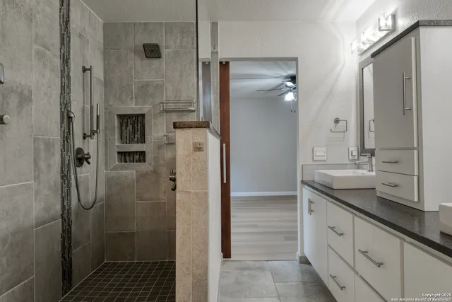 a bathroom with a glass shower door