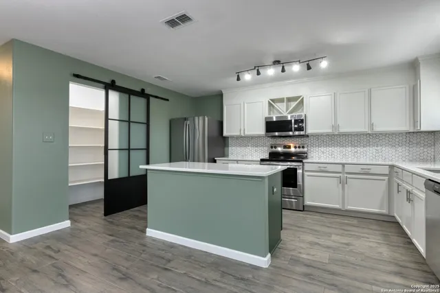 a kitchen with granite countertop a stove top oven and sink
