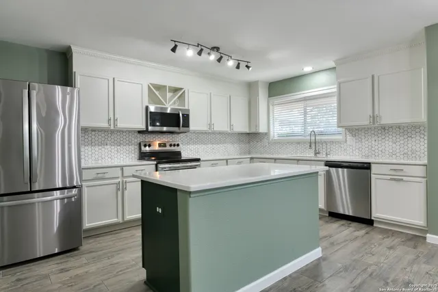 a kitchen with a refrigerator sink and microwave