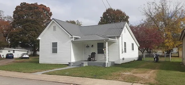 a view of a white house with a yard