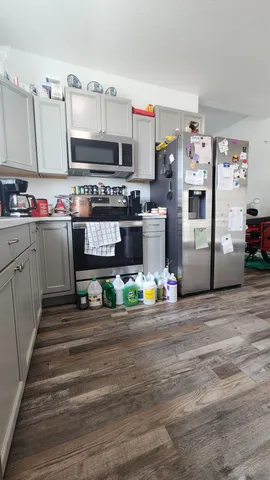a kitchen with stainless steel appliances a stove and cabinets