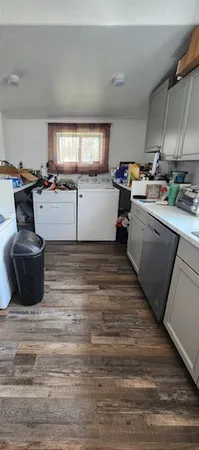 a kitchen with a refrigerator and a stove top oven