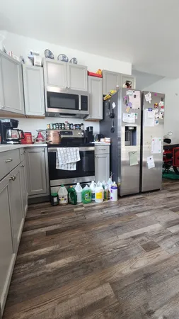 a kitchen with stainless steel appliances a stove and cabinets
