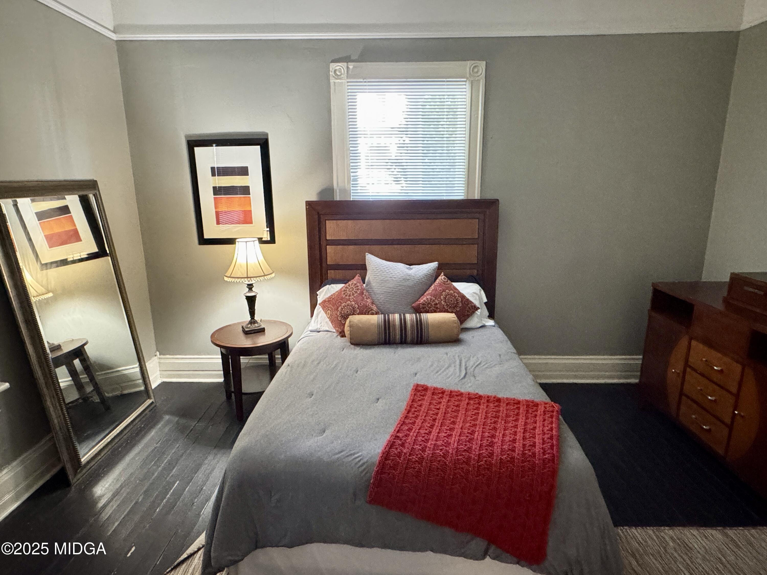 940 Cole Street Macon, GA 31201 - Photo 11 of 22 a bedroom with a bed and wooden floor