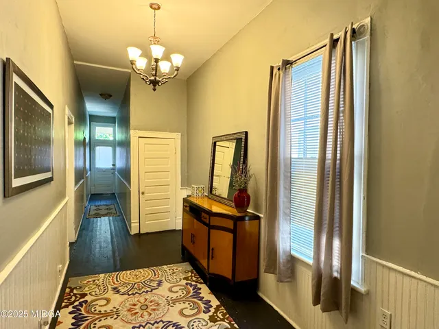 a hallway with sliding door and wooden floor