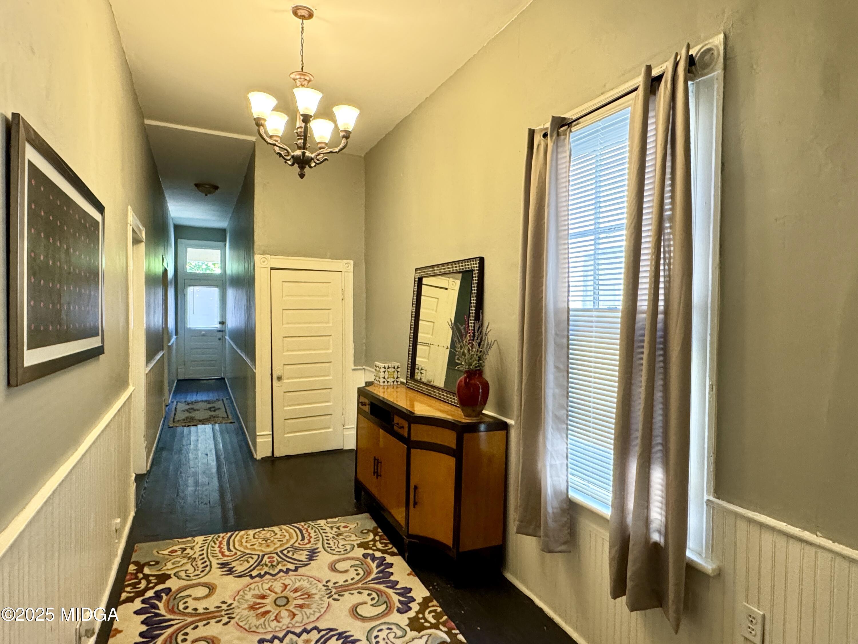 940 Cole Street Macon, GA 31201 - Photo 3 of 22 a hallway with sliding door and wooden floor