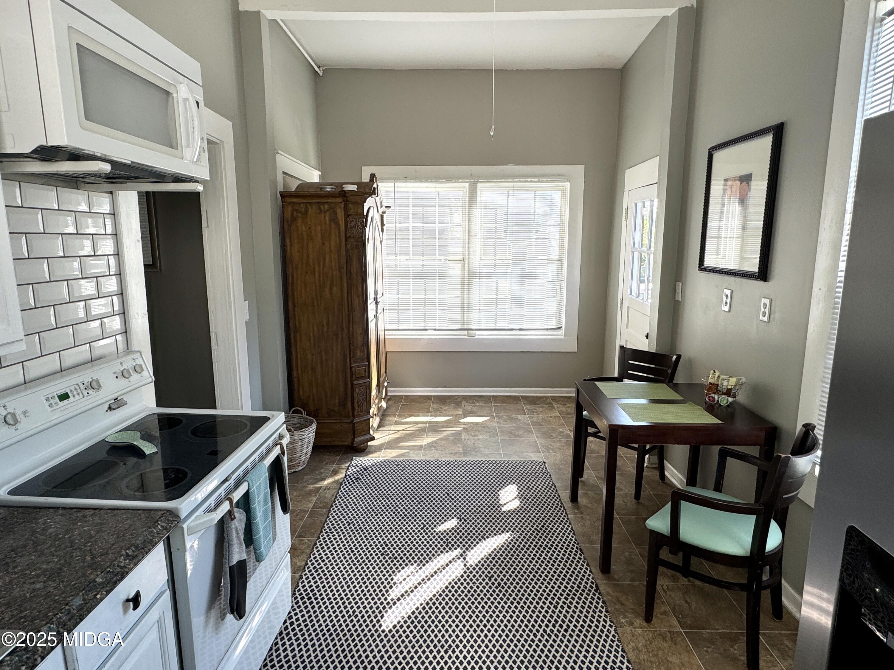 940 Cole Street Macon, GA 31201 - Photo 7 of 22 a kitchen that has a sink a stove and chair