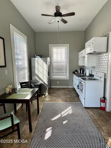 a kitchen with granite countertop a stove a sink and a refrigerator
