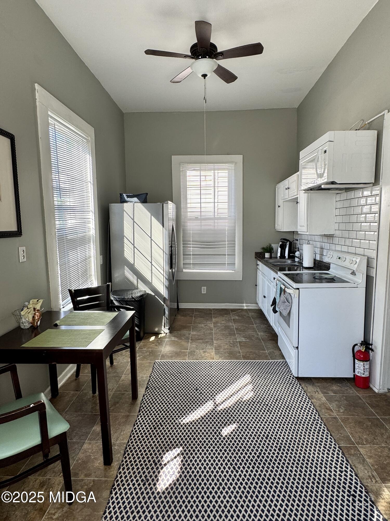 940 Cole Street Macon, GA 31201 - Photo 8 of 22 a kitchen with granite countertop a stove a sink and a refrigerator