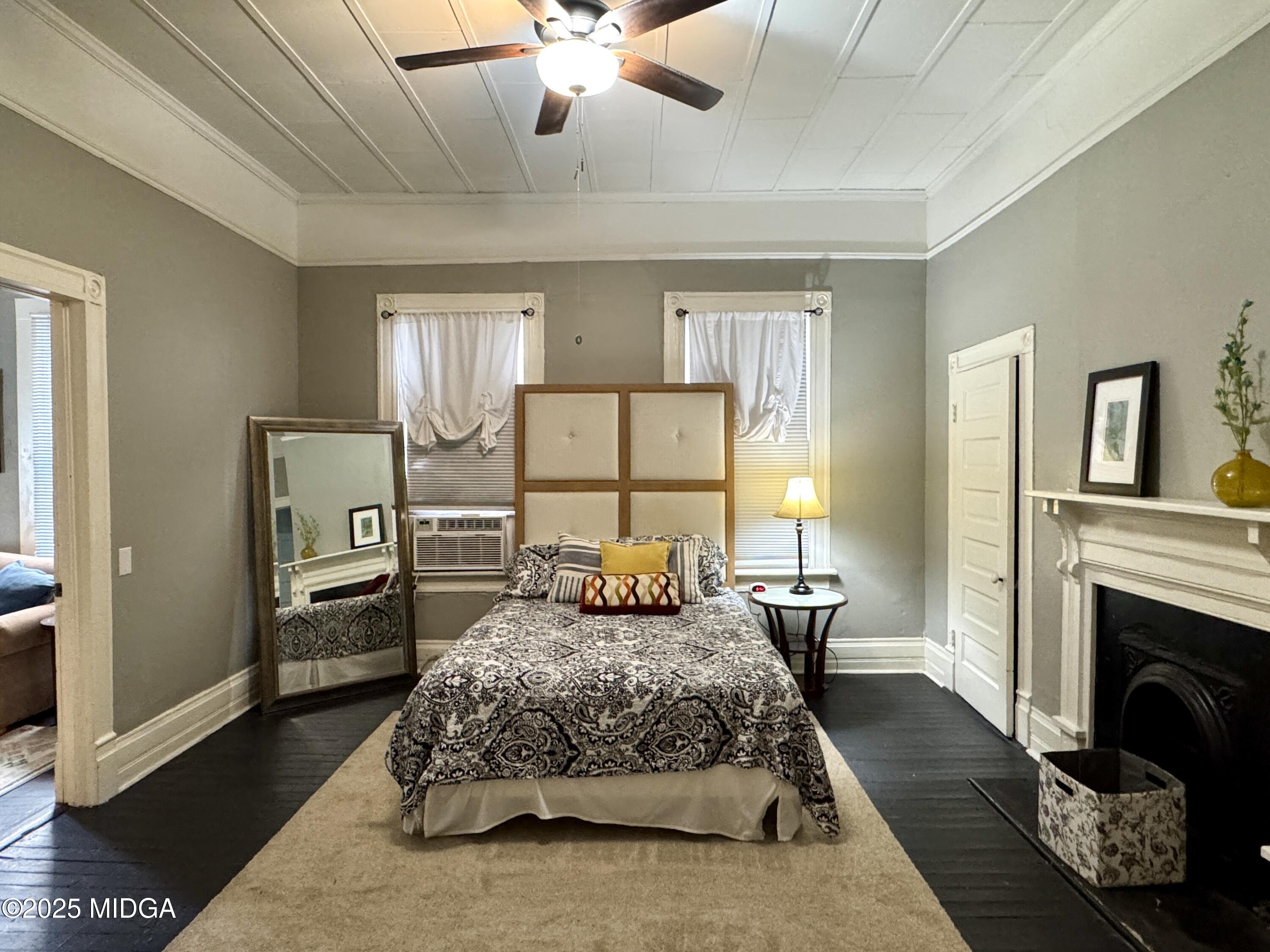 940 Cole Street Macon, GA 31201 - Photo 10 of 22 a bedroom with a large bed and a fireplace