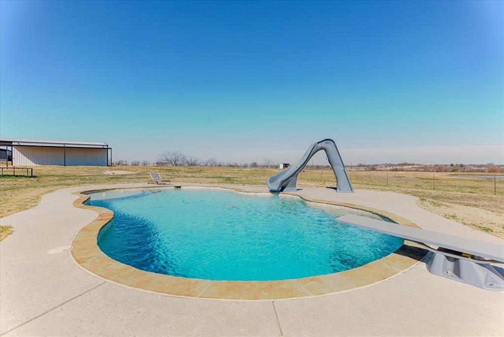 a view of a swimming pool and a chair