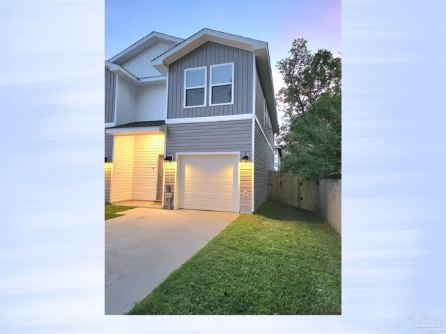 a view of a house with a backyard