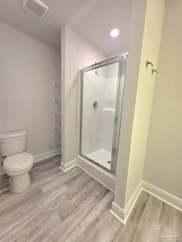 a bathroom with a shower toilet and sink