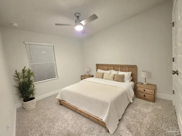 a bedroom with a bed and a potted plant
