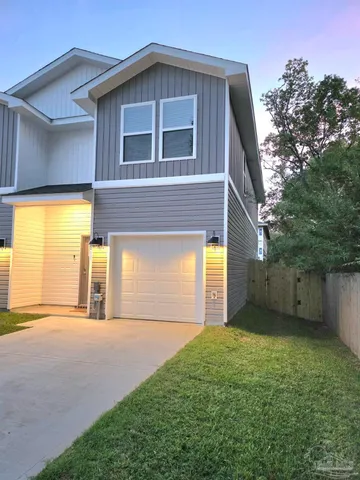 a view of a house with a backyard
