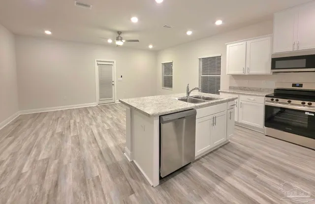 a kitchen with a sink stove and cabinets